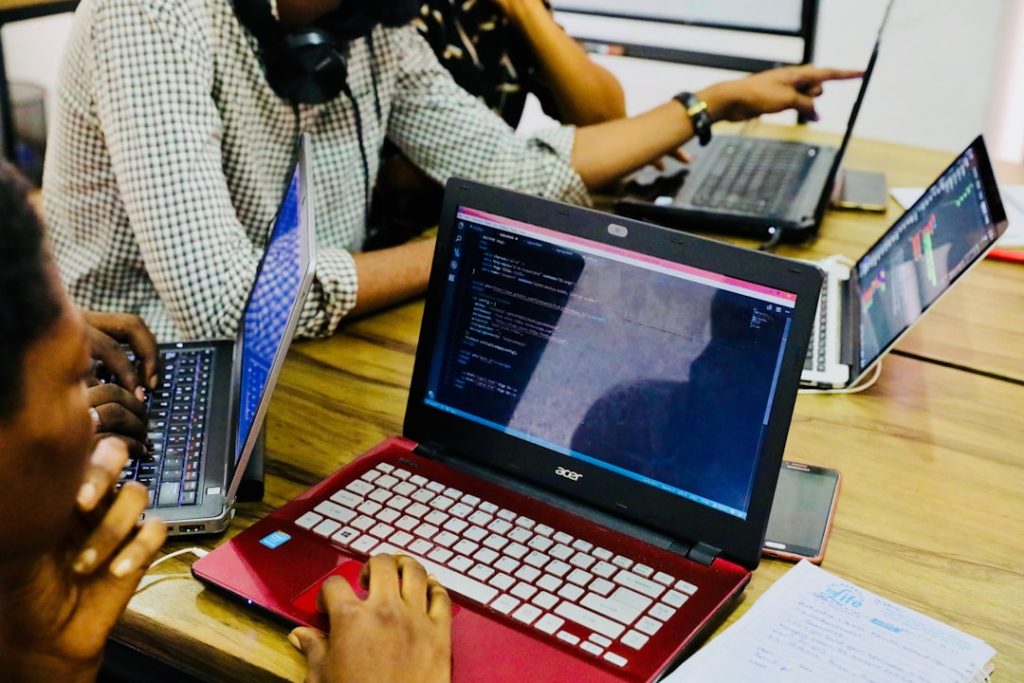 person-using-black-and-red-acer-laptop-computer-on-table-ygocjz9ugmk